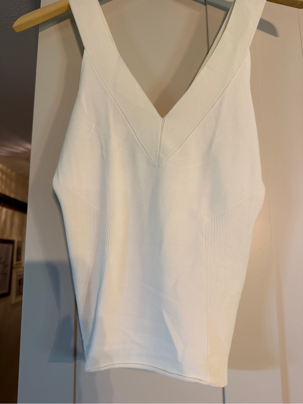 DKNY cream sleeveless vneck sweater, somewhat ribbed on the sides, size S